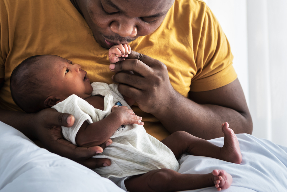 new born baby getting fed with a bottle.